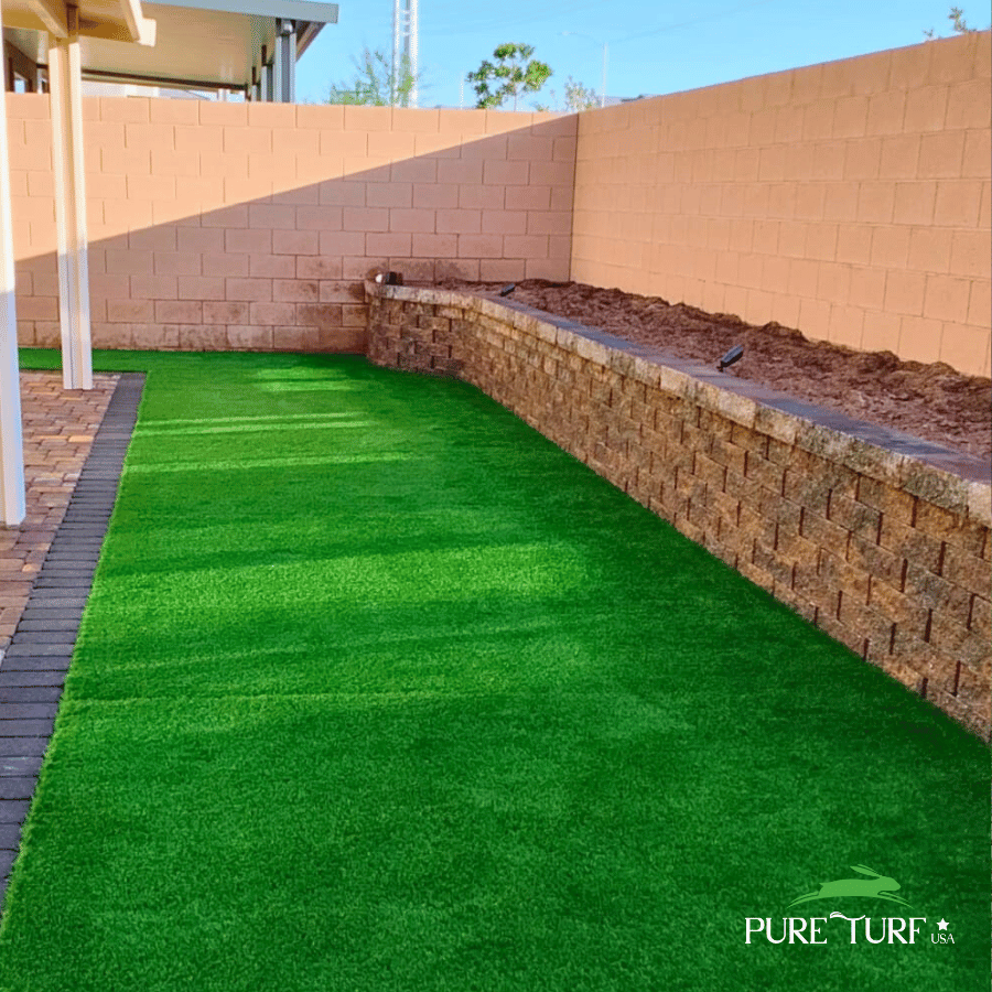 Backyard artificial turf with stone planter wall