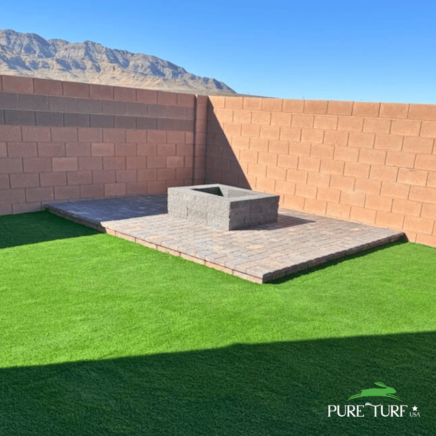 Fire pit on paver pad surrounded by artificial turf