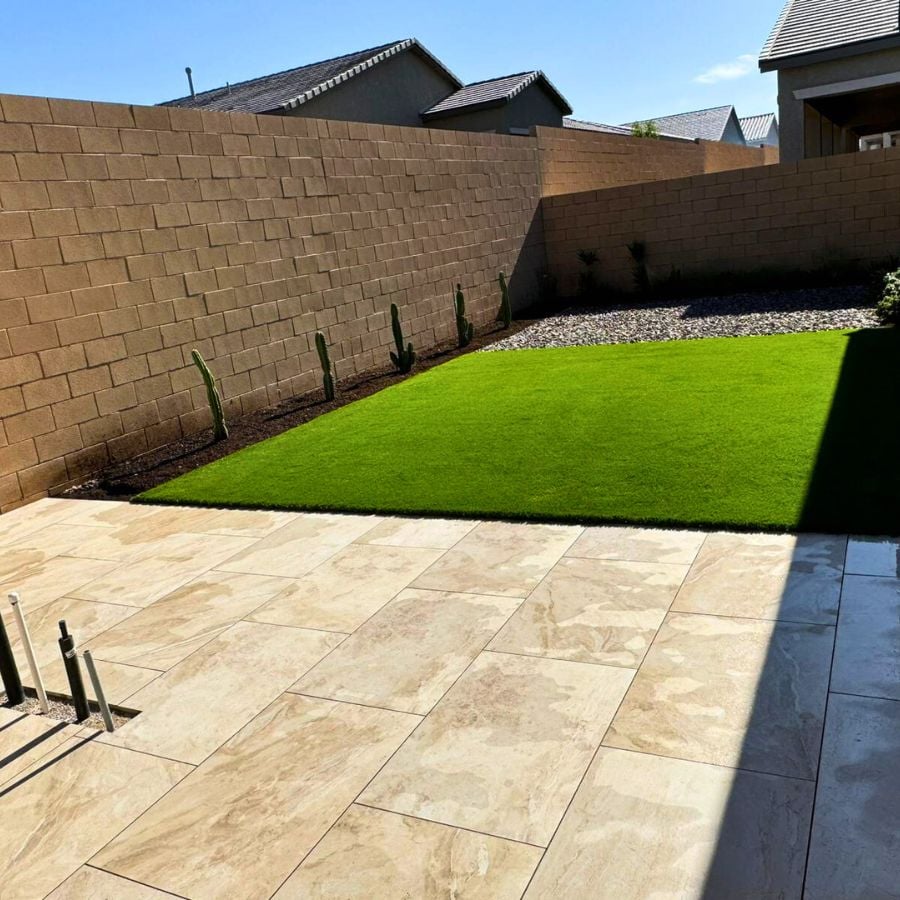 Travertine patio transitioning to artificial turf